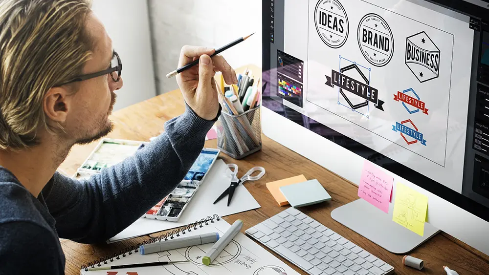 Logo Designer working on Computer